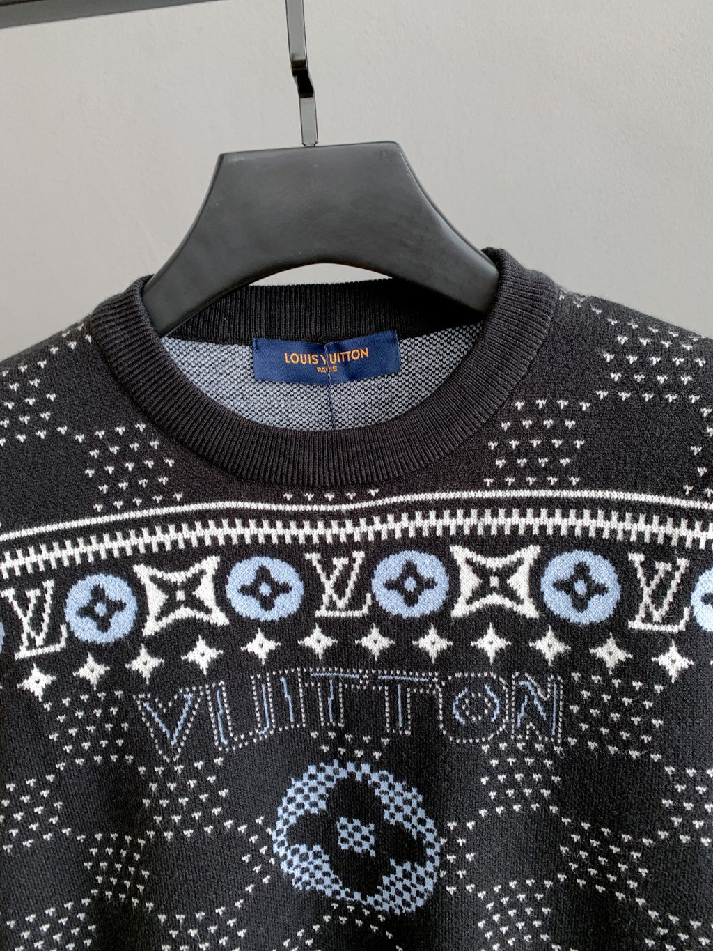 Close-up crew-neck knit sweater with white geometric monogram motifs and ribs