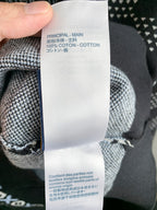 Care label on knit sweater interior lining with cotton text