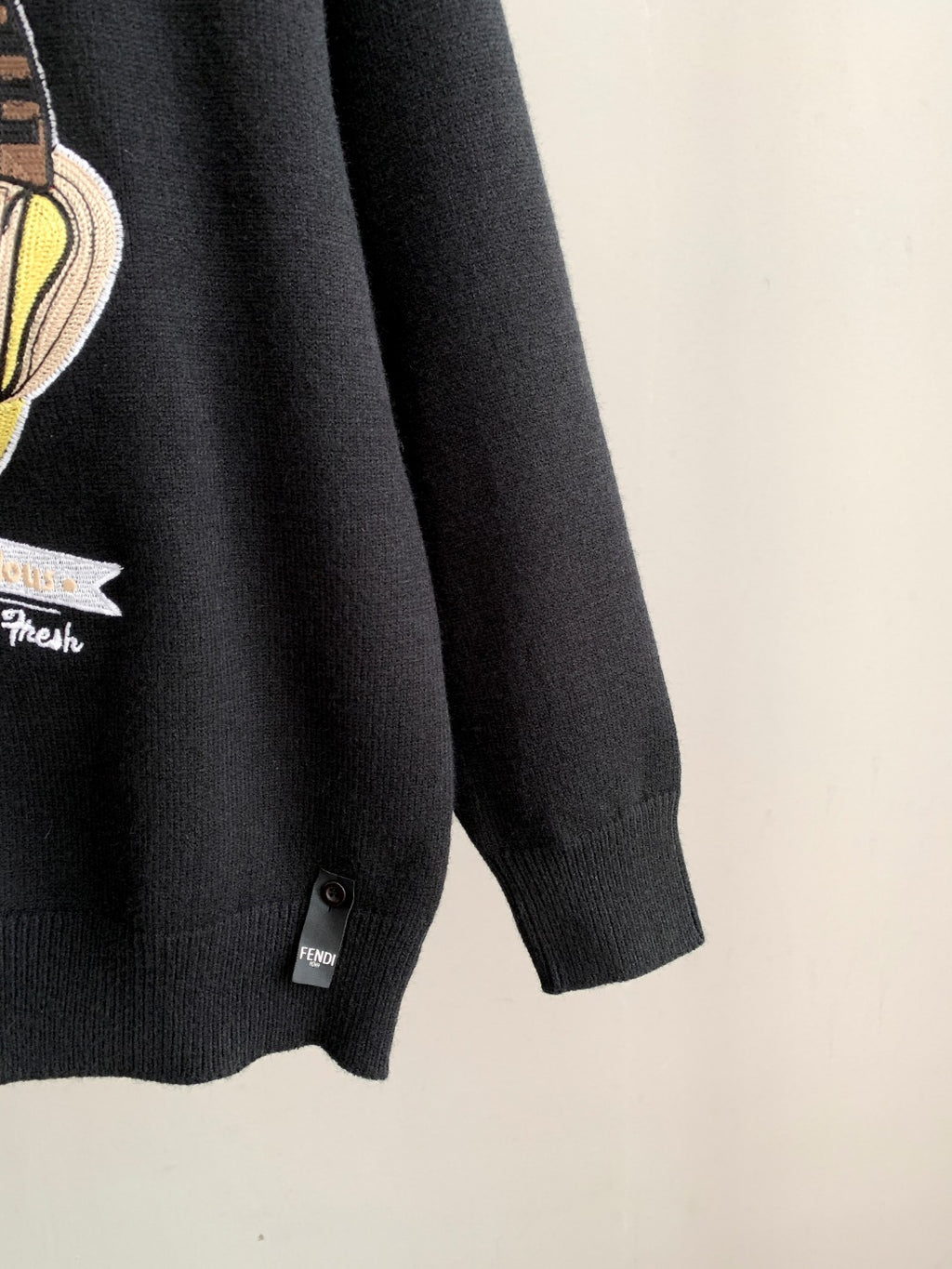 Black Fendi crewneck sweater sleeve hem with small brand tag