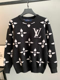 Black knit sweater with white monogram-style geometric pattern, crew neck, long sleeves