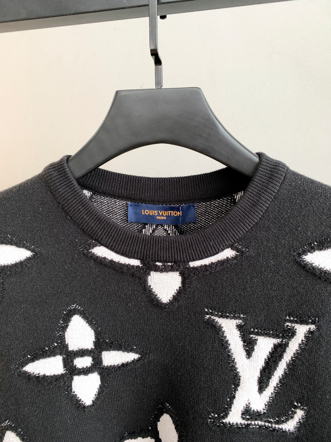 Black knit sweater neckline with ribbed crew collar and Louis Vuitton brand label