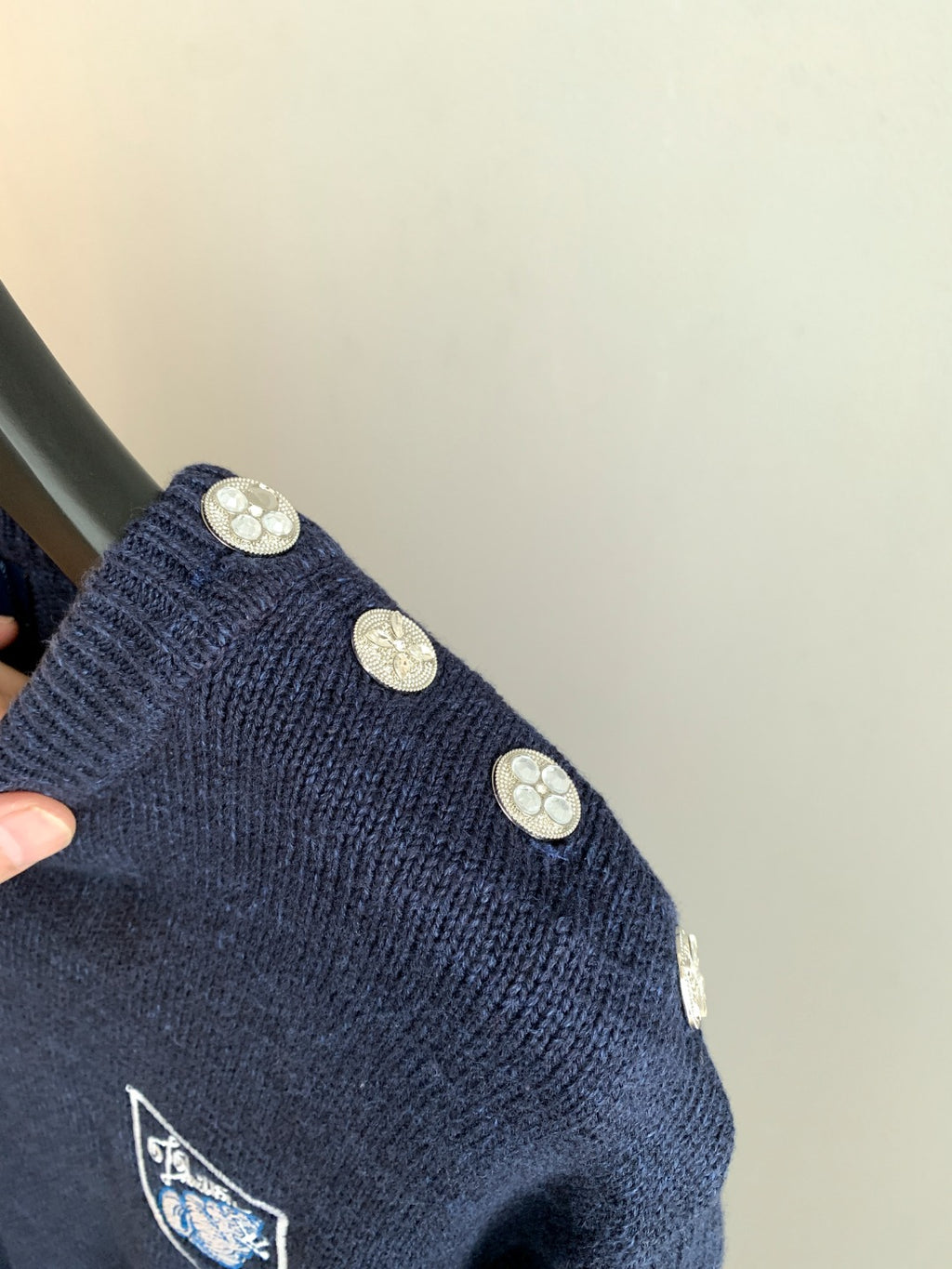Louis Vuitton knit sweater with decorative gold buttons on shoulder and crest emblem