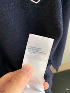 Louis Vuitton sweater care label showing 100% cotton on inner tag