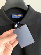 Long-sleeve polo collar with button, blue monogram, attached brand hang tag