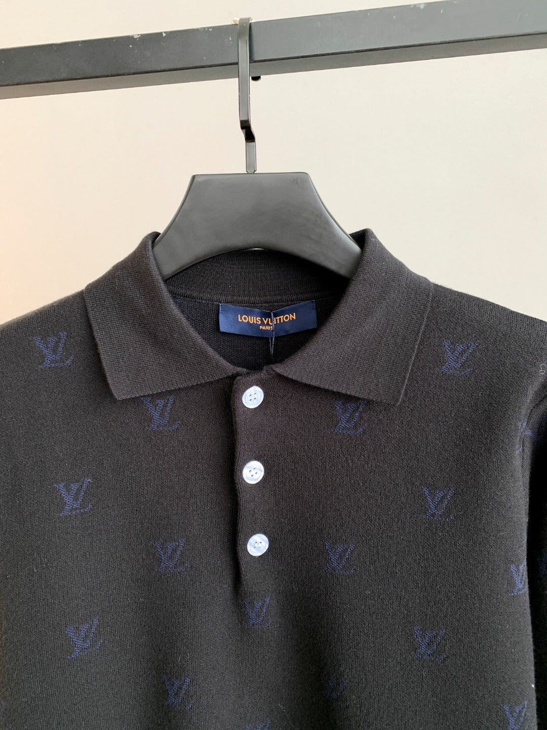 Long-sleeve polo sweater with dark collar and three button placket, blue monogram