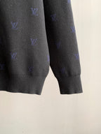 Long-sleeve polo hem and cuffs with blue monogram pattern on dark gray knit