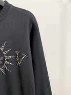 Dark knit sweater sleeve with partial rhinestone design on the side