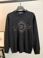 Dark knit long-sleeve sweater with rhinestone emblem on the chest