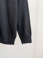 Dark knit sweater with ribbed cuffs and hem