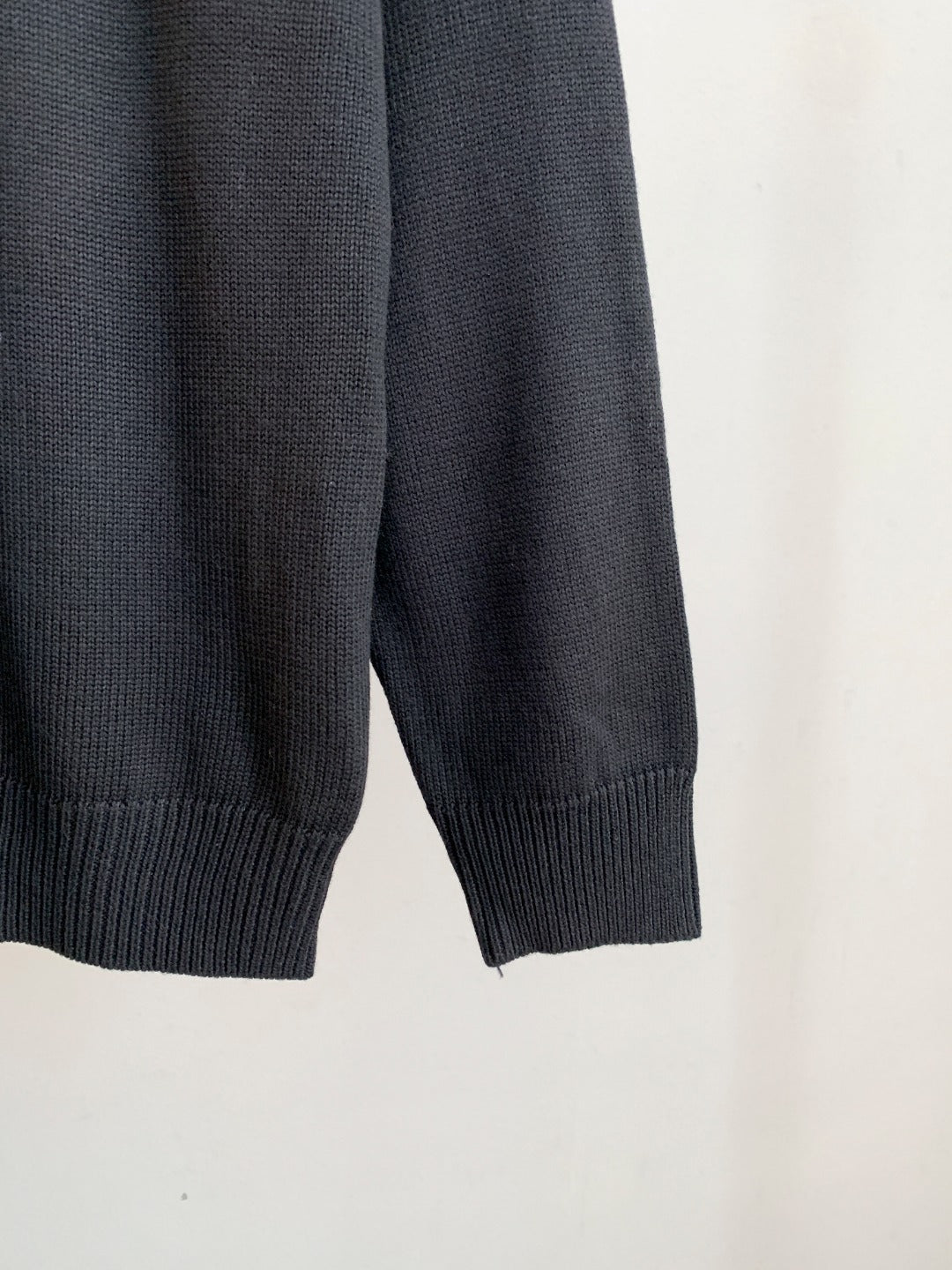 Dark knit sweater with ribbed cuffs and hem