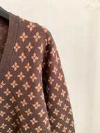 Brown monogram cardigan sleeve with repeating flower motif pattern
