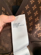 Clothing care label showing fabric composition: 100% cotton