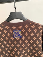 Brown monogram cardigan with blue logo patch at the back neck