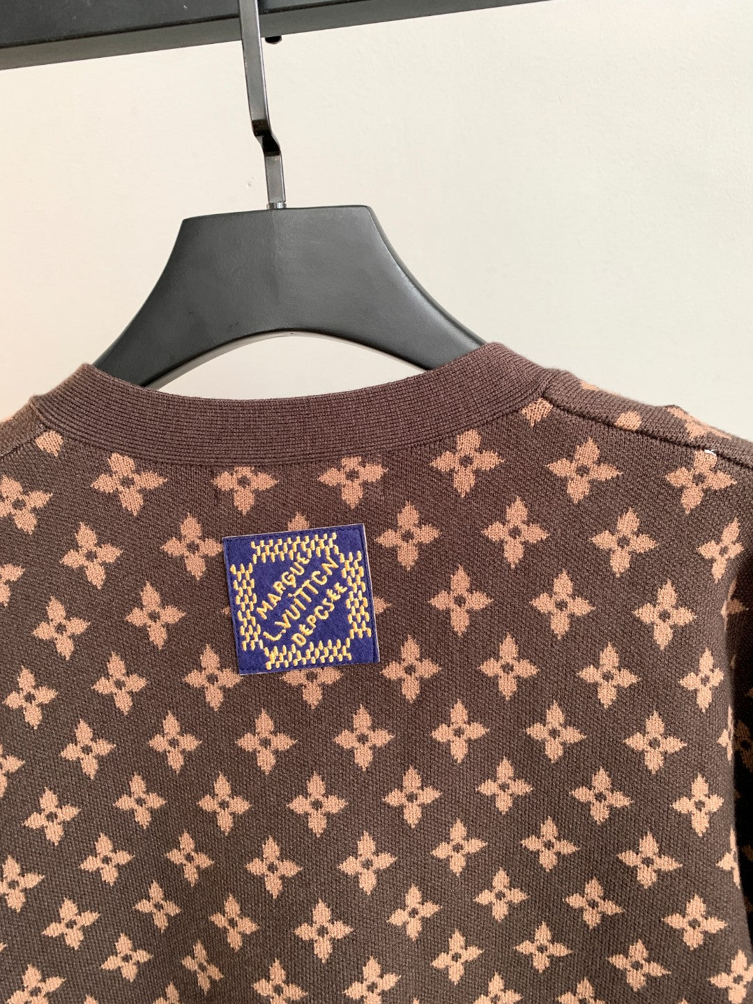 Brown monogram cardigan with blue logo patch at the back neck