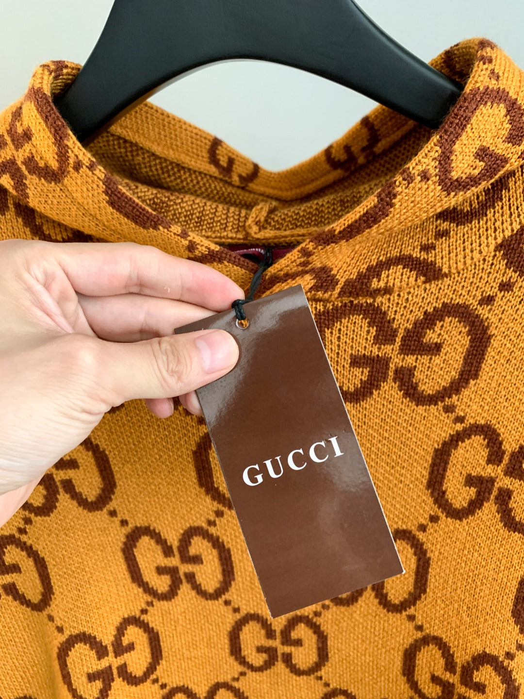 Gucci GG monogram knit sweater neckline detail with Gucci hang tag