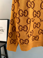 Gucci GG monogram knit sweater close view of hem and pattern, orange
