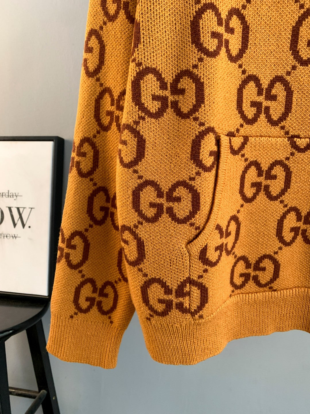 Gucci GG monogram knit sweater close view of hem and pattern, orange
