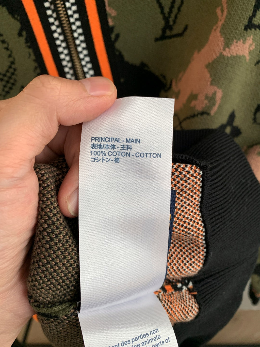 Louis Vuitton jacket interior tag area, ribbed cuff, orange trim on monogram camo
