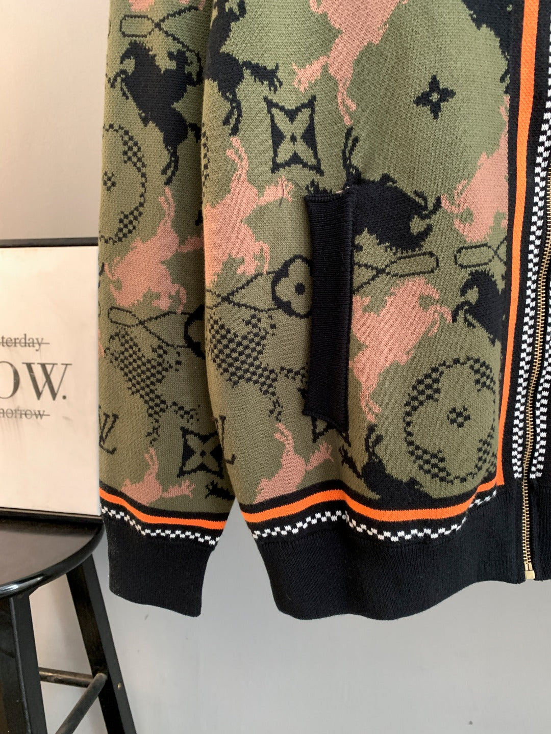 Louis Vuitton zip-up jacket hem view, dark ribbed trim and orange piping, monogram camo