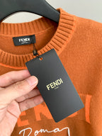 Fendi orange sweater with Fendi logo tag attached near neckline