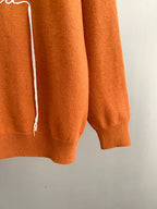 Fendi orange sweater sleeve with hanging white drawstring detail