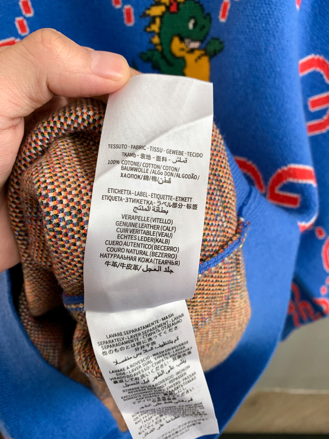 Blue knit sweater with inner fabric and care label visible
