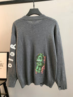 Gray knit sweater with ribbed crew neck and colorful character graphic on back