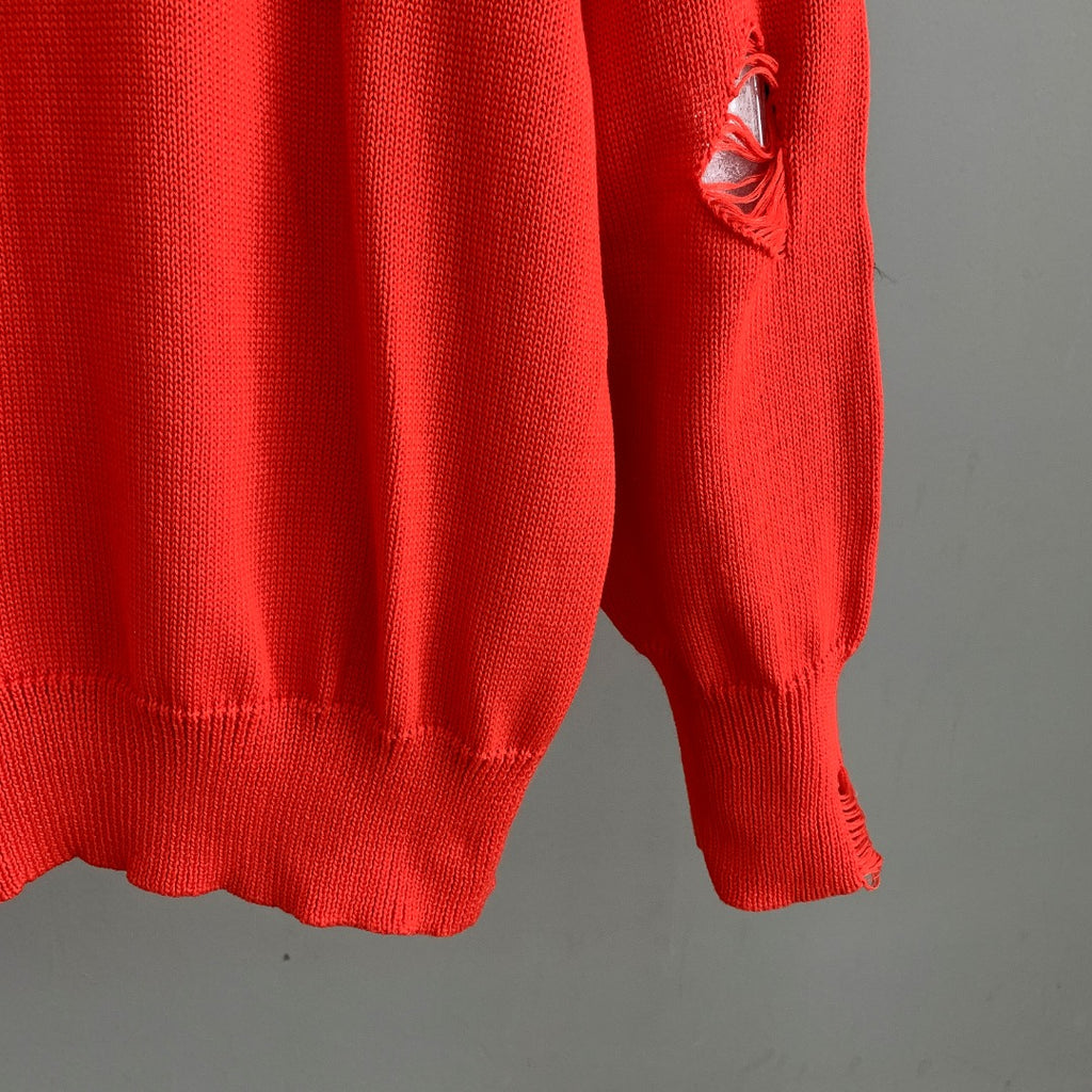 Dior red knit sweater sleeve with small distressed hole and ribbed cuff