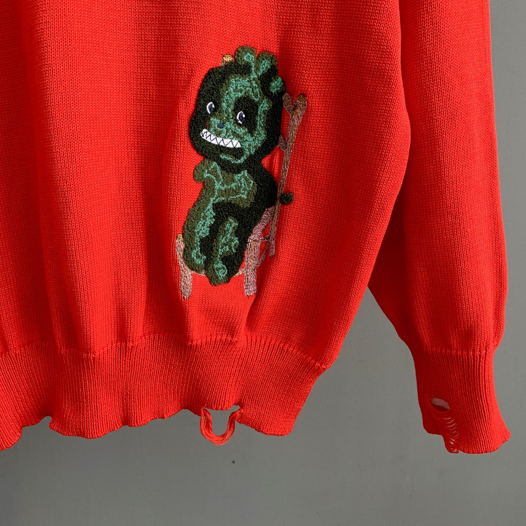Dior red knit sweater with dinosaur graphic and ribbed cuffs at hem