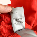 Dior red knit sweater care label showing 100% content and washing symbols