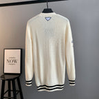 Ivory knit cardigan back view with ribbed black-and-white hem