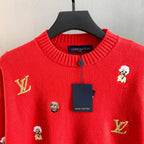 Red sweater close-up with ribbed collar, button placket, and Louis Vuitton label