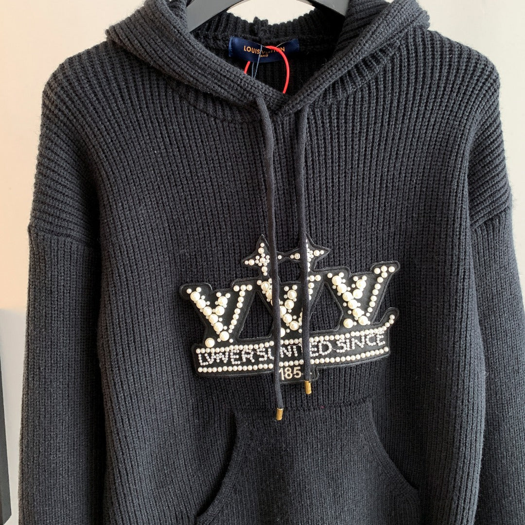 Dark hooded knit sweater with rhinestone crown-style logo and zip front