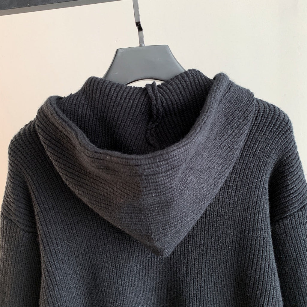 Back view of dark hooded knit sweater with ribbed hood and shoulder texture