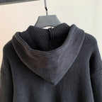 Back view of dark hooded knit sweater with ribbed hood and shoulder texture