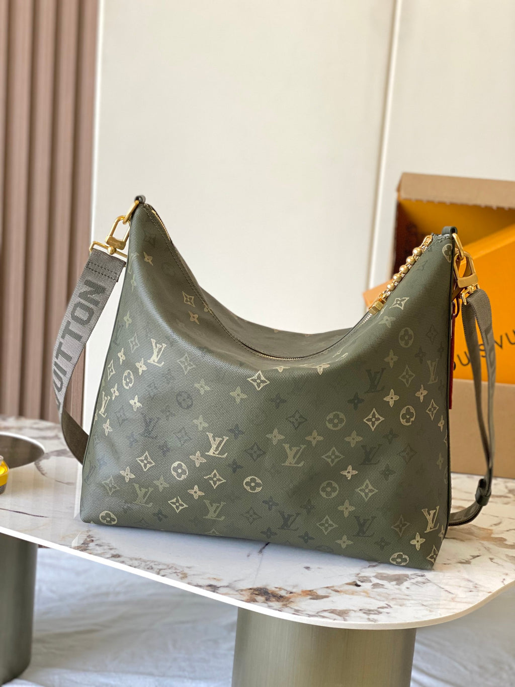 Louis Vuitton monogram hobo bag in dark green with gold-tone clasp and crossbody strap