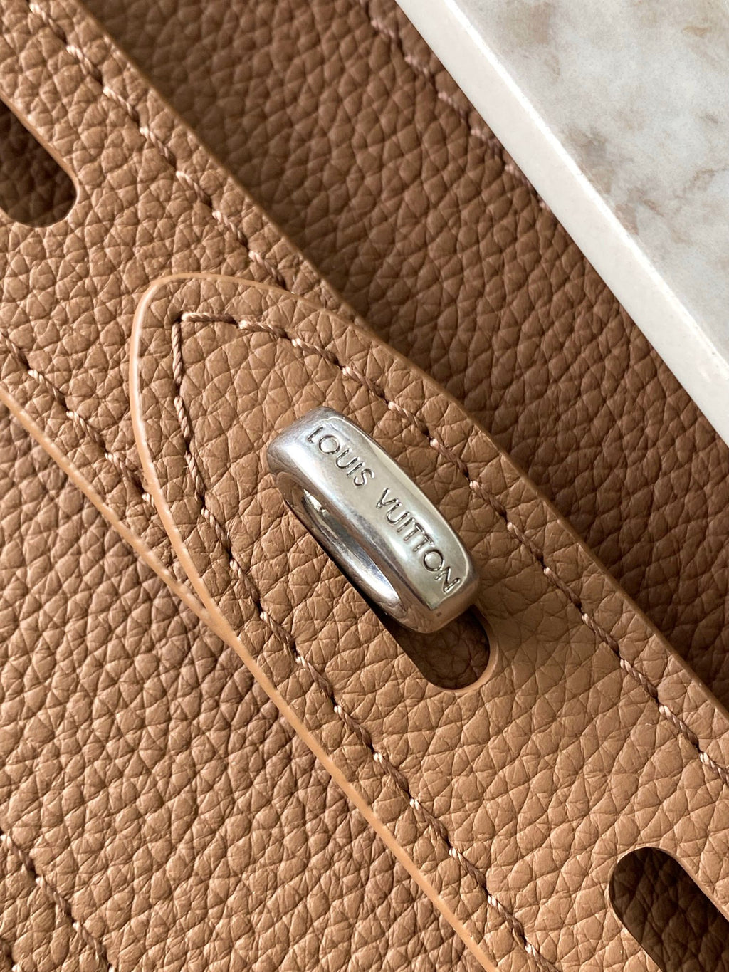Louis Vuitton tan pebbled leather panel with embossed logo and metal rivet