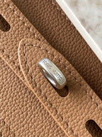 Louis Vuitton tan pebbled leather panel with embossed logo and metal rivet