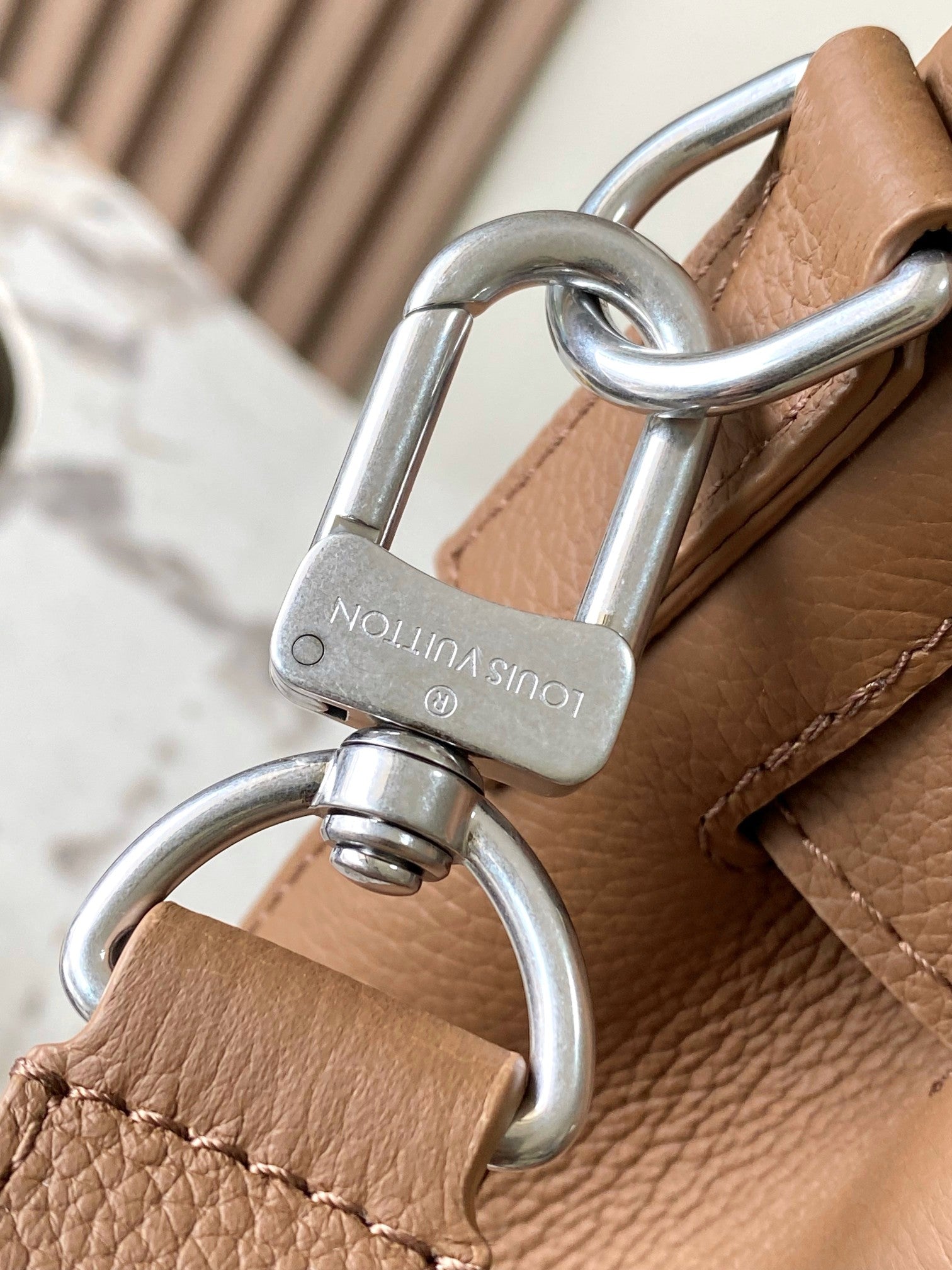 Louis Vuitton tan leather strap attachment with metal rings and engraved hardware