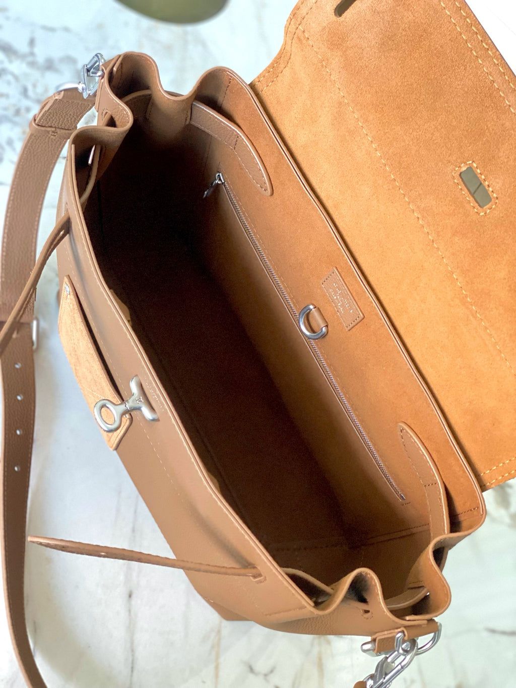 Louis Vuitton tan leather bag interior view with open top and inner pocket