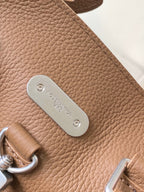 Louis Vuitton tan leather side with oval metal logo tag and top ring hardware