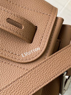 Louis Vuitton tan leather flap with cutout slot and embossed brand lettering