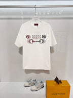 White Gucci crewneck T-shirt with front Gucci logo graphic, short sleeves