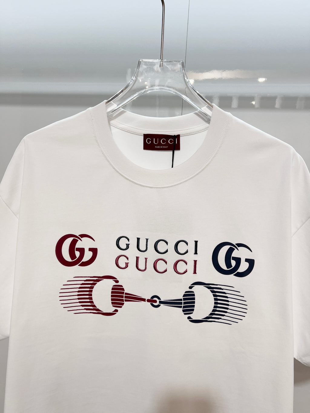 White Gucci crewneck T-shirt with front graphic Gucci logo, close-up