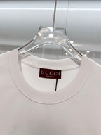 White Gucci crewneck T-shirt with neckline tag, front view close-up