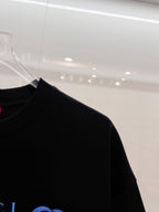 Black Gucci T-shirt side view with hanging tag, short sleeves and crew neck