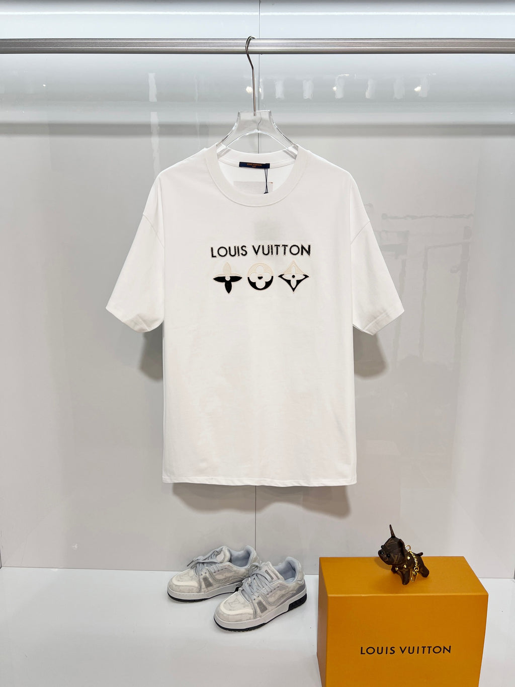 White T-shirt with Louis Vuitton logo and black chest icons, short sleeves