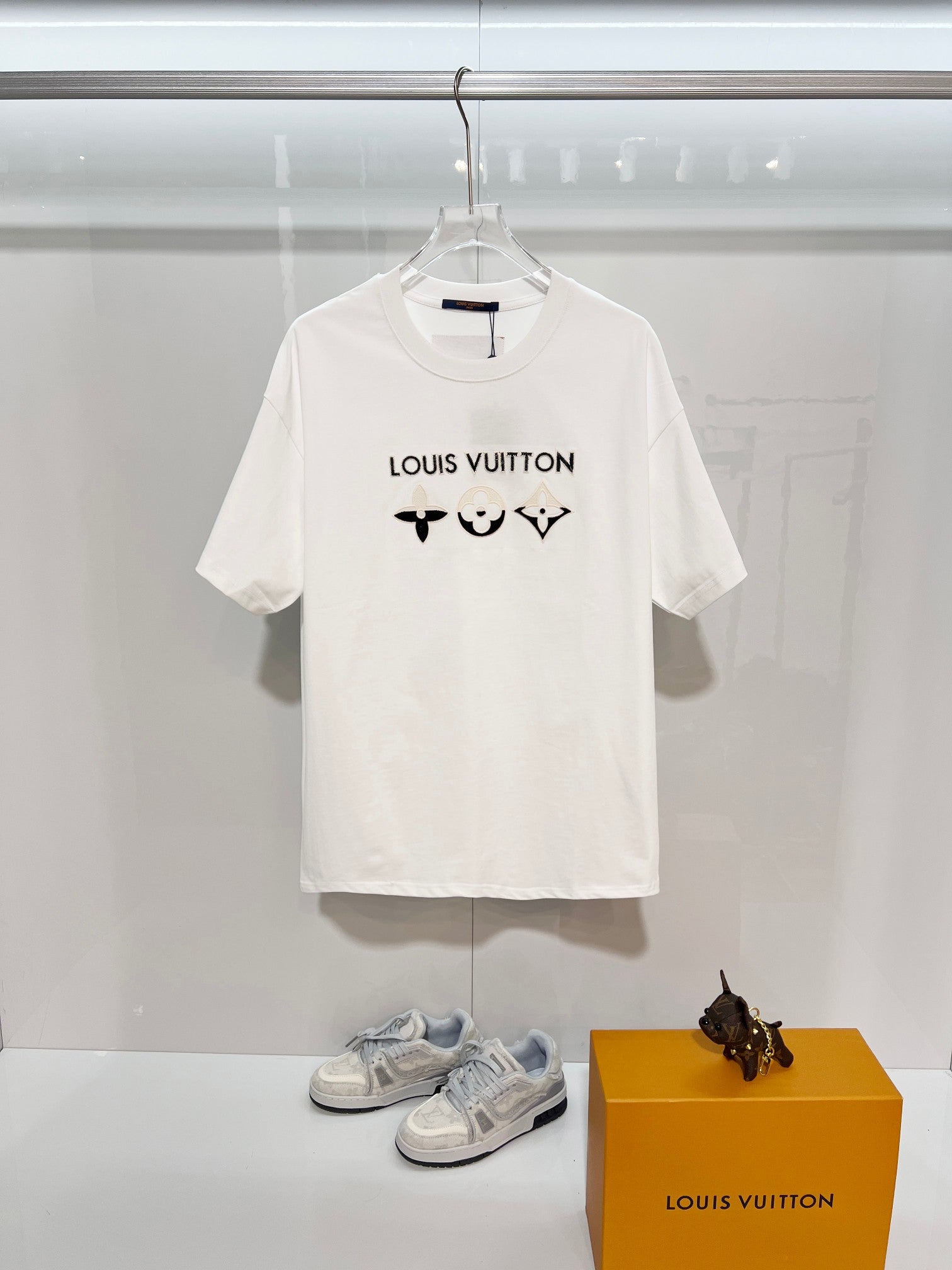 White T-shirt with Louis Vuitton logo and black chest icons, short sleeves
