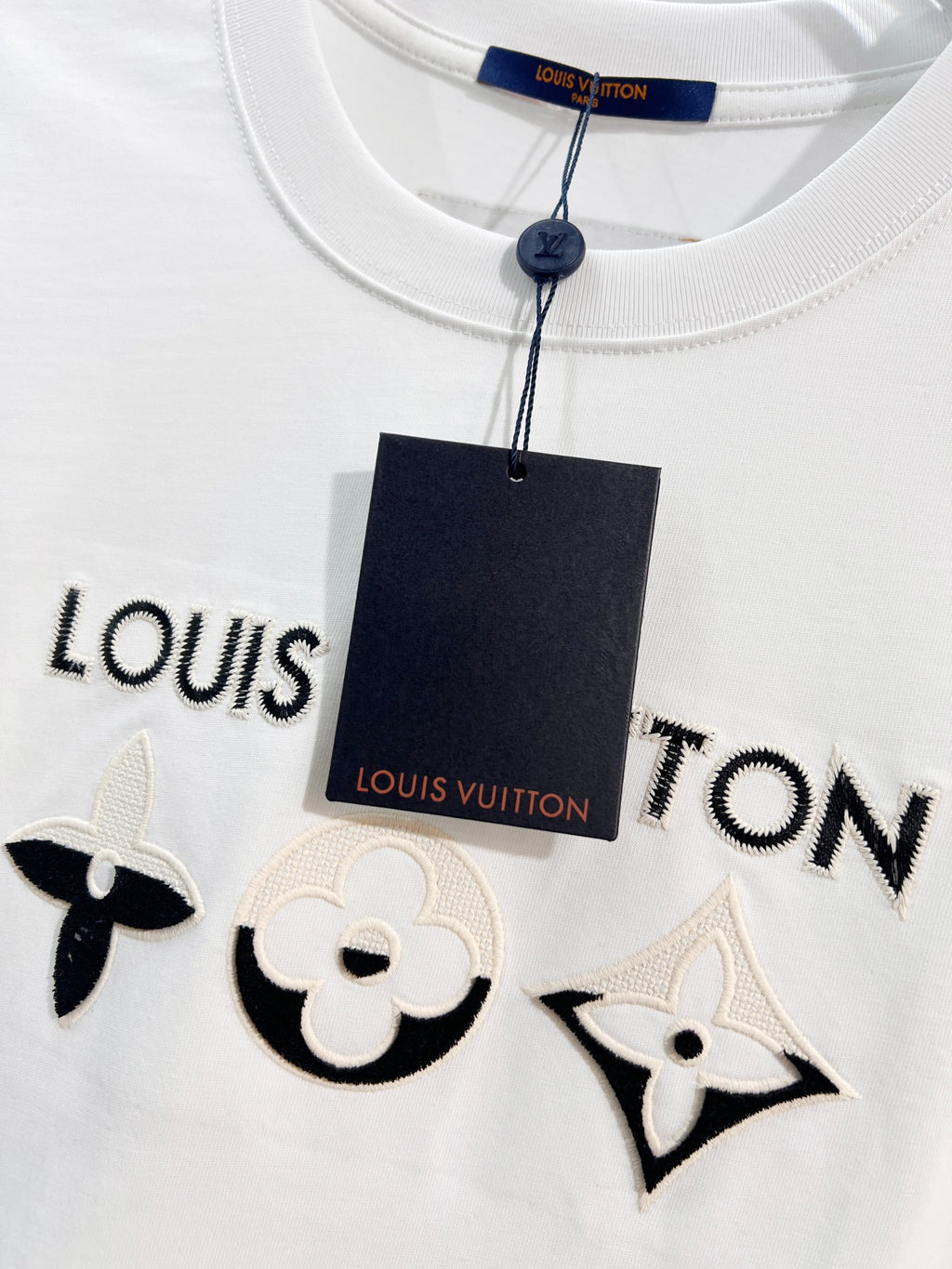 White T-shirt with Louis Vuitton logo trim and embroidered black chest icons