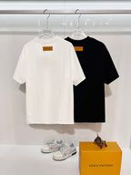 White and black Louis Vuitton T-shirts with square logo label at back neck, short sleeves